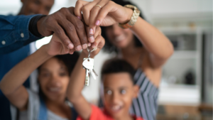 Family holding keys to celebrate having access to housing