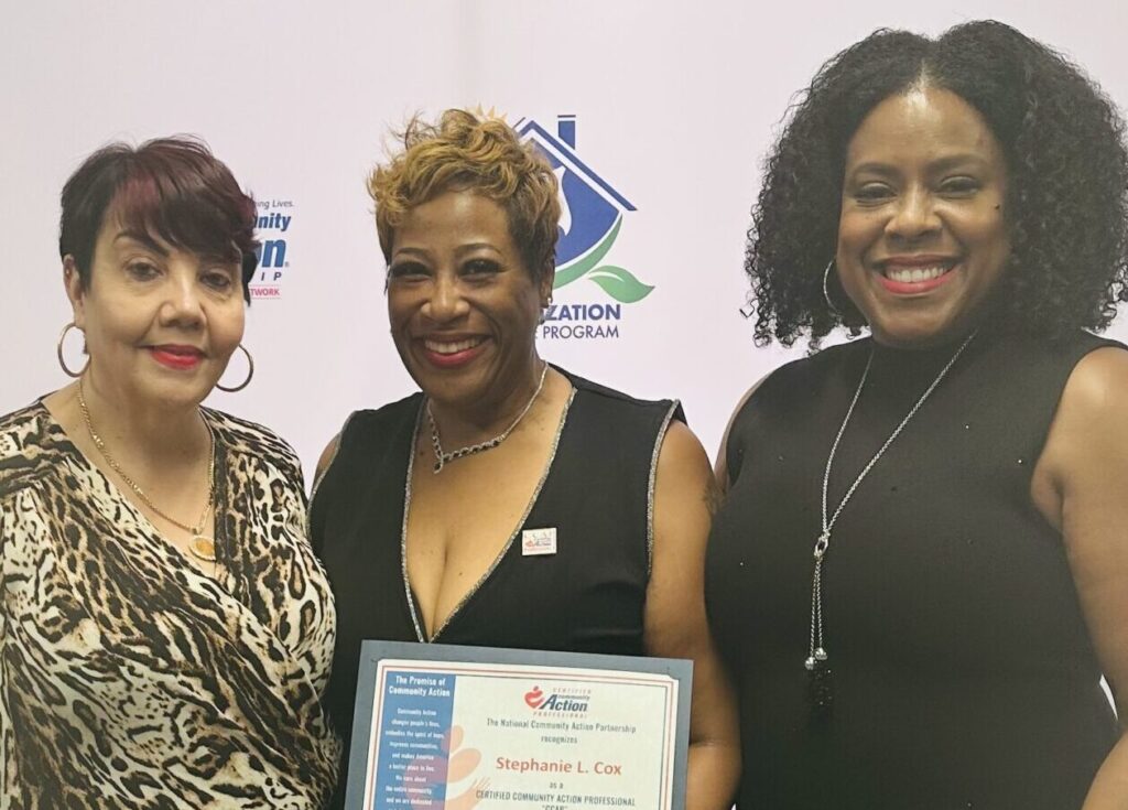 Kathleen Lowe Jacobs and Dr. Ericka J. Whitaker stand with attendee and award